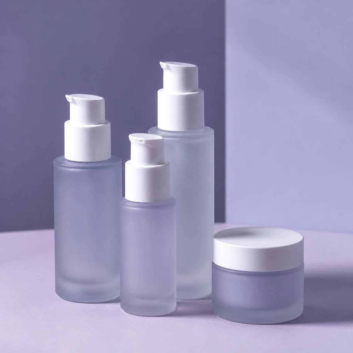 Frosted glass serum bottles and a lilac jar on a soft violet background.